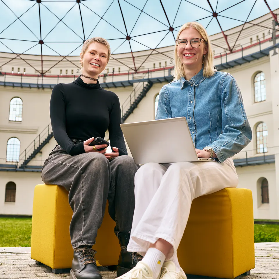 Zwei Kolleginnen mit Laptop unter einer Glaskuppel, Employer-Branding-Fotoshooting