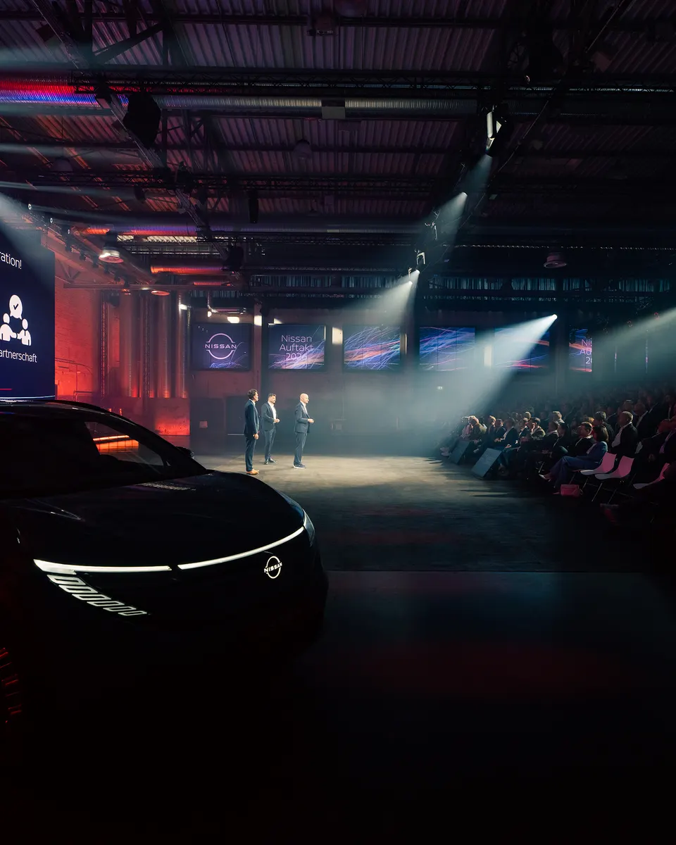 Nissan-Fahrzeug im Scheinwerferlicht einer dunklen Eventhalle